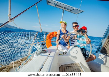Happy father with adorable daughter and son resting on a big yacht Royalty-Free Stock Photo #1101688445