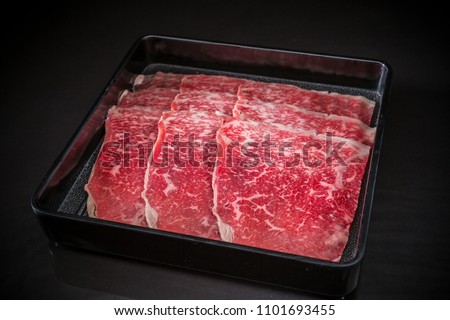 Thin sliced beef for Shabu Shabu, Sliced Wagyu Beef, shabu shabu, sukiyaki, raw food on black background