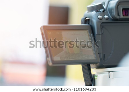 Photographers using camera located on tripod to take pictures of online shopping for sale on web site microstock