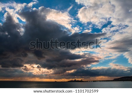
Storm clouds over the sea at sunset time
