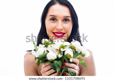 Beautiful girl with a bouquet of white peonies on a white background