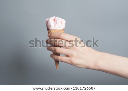 Woman hand holding an Strawberry ice cream cone