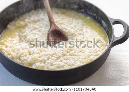 Risotto rice boiling with chicken stock and wine 