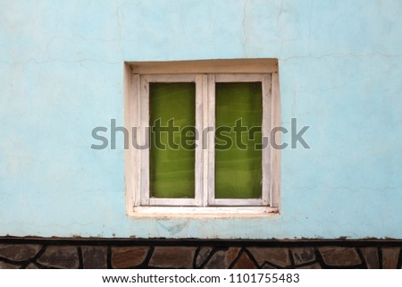 full picture of celestial wall and window with green curtains