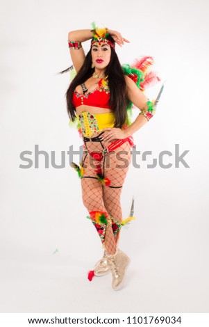 Dark haired hispanic woman in Carnaval costume and athletic shoes posing on clean white background