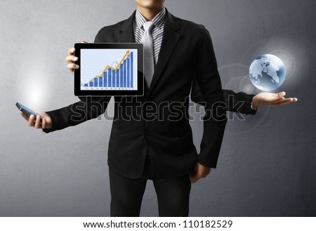 holding a glowing earth and tablet,mobile phone in his hands