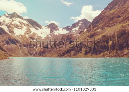 Beautiful lake in the snowy mountains of Altai. Russia, Siberia. Tinted instagram photos.