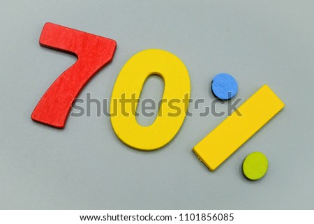 sale 70% - wooden sign symbol lie on gray table background.