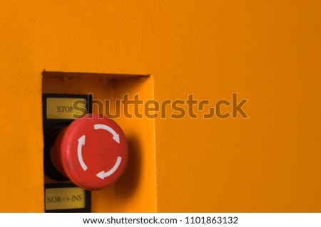 Red emergency switch on yellow steel box, machinery control button in case of accident following safety criteria