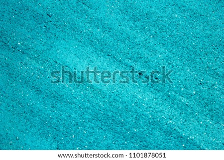 Turquoise shiny textured acrylic paint with glitter background