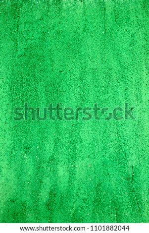 Green shiny textured acrylic paint with glitter background