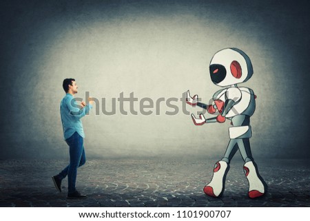 Young businessman holding fists ready to fight against robot. Rivalry between human and technology. Danger of losing the job, replacing the human work force with the robotic. Artificial intelligence.