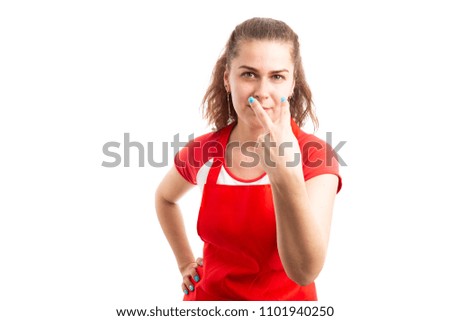 Young female supermarket or retail worker making pay attention gesture with fingers as look into my eyes concept isolated on white background
