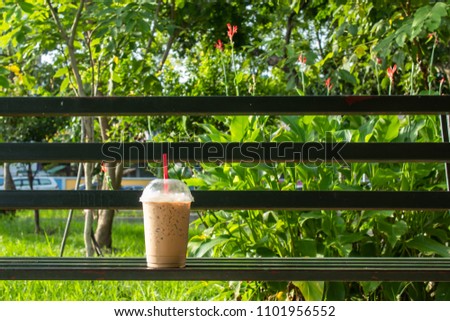 Coffee cool moment the sun is low. On a steel chair in the park