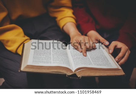 Two women studying the bible. Royalty-Free Stock Photo #1101958469
