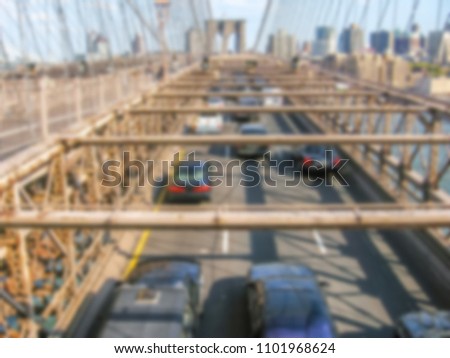 Defocused background with aerial view of a number of cars cross the Brooklyn Bridge in New York, United States.  Intentionally blurred post production for bokeh effect.