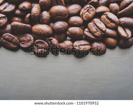 Roasted coffee beans macro on dark grey background with copy space. Shallow DOF, selective focus. Film effect filter