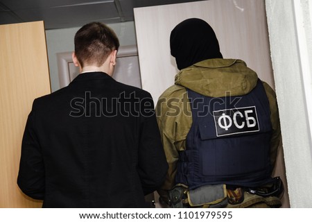 Employee of the FSB and a man in a black suit Royalty-Free Stock Photo #1101979595