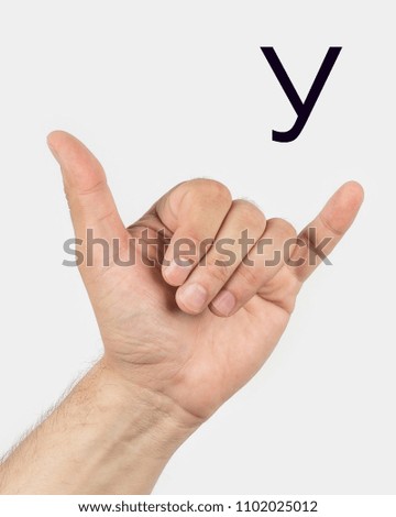 Alphabet in Russian sign language.  A symbol 21 from 33. A man's hand on a light background.