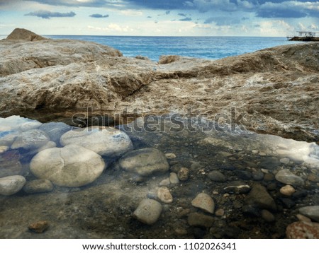 Stones in a puddle of mountainous terrain of Turkey and the sea