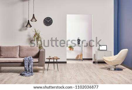 white and dark blue wall background grey sofa and white chair decor with technological tool.