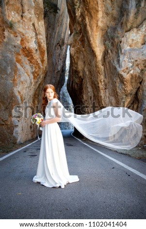 Beautiful bride portrait in the mountain rocks.