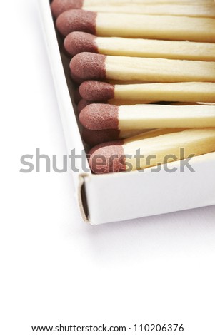 Matches in a yellow match box on white background