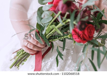 a bridal bouquet in the hands of the bride. Red roses.