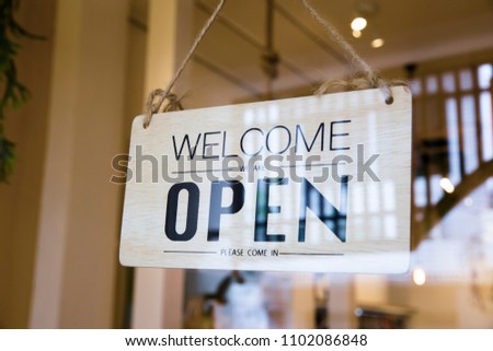 Close up of the sign board "Open" shop or cafe of the window at the door