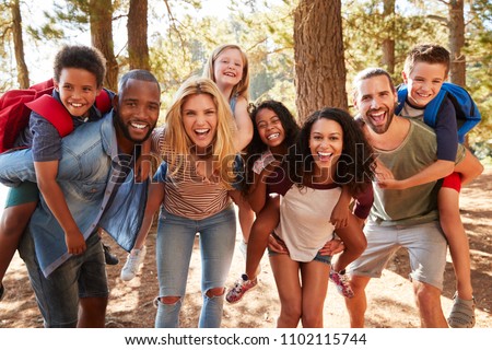 Portrait Of Family With Friends On Hiking Adventure In Forest Royalty-Free Stock Photo #1102115744