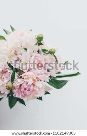 top view of light pink peony bouquet on white