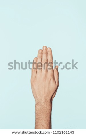 partial view of man gesturing by hand isolated on blue background 