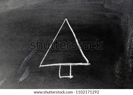 White chalk hand drawing in tree shape on blackboard background