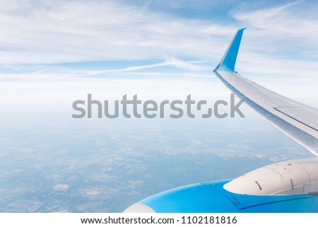 Beautiful view from airplane with wing and blue sky background
