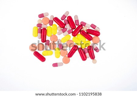 a lot of type of medicine yellow vitamin 
orange round pill  red capsule small pink round tablet and two colors capsule isolate on white background
