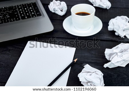 Concept in search ideas. Creased paper of idea. Modern workplace with notebook or laptop, cup of coffee. Still life, business, office supplies or education concept. Flat lay. Top view.