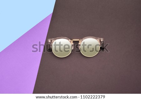 Minimal style. Minimalist Fashion photography. Fashion summer is coming concept. Sunglasses on a colorful background