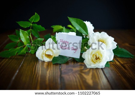 beautiful white blooming roses on a wooden table