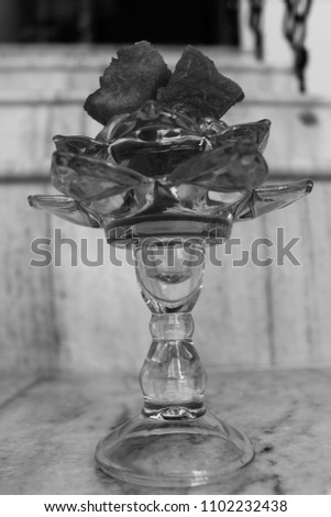B&W monochrome pic having watermelon slice in flower shaped glass with white background