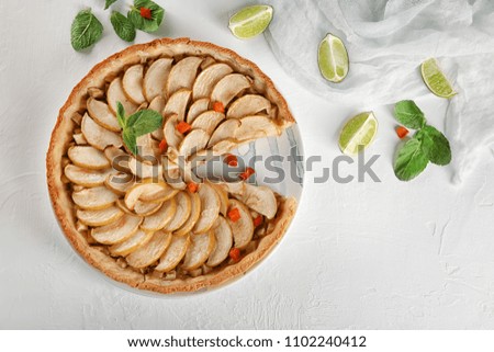 Plate with tasty homemade apple pie on table