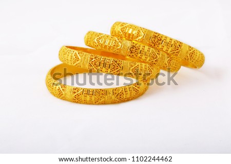Designer Gold Bangles Royalty-Free Stock Photo #1102244462