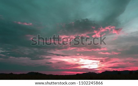 Beautiful Sunset. The sky is pink, the Gray clouds are scattered over the sky.