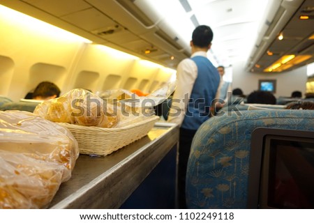 Meals on the plane.  Stock image of food served on board of economy class airplane on the table. Tasty lunch served in the aircraft interior