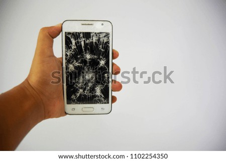 broken glass touch screen white mobile phone in hand isolate on white background