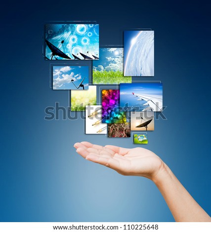 touch pad PC and streaming images buttons on women hand on background blue