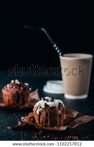 Sweet chocolate muffins with cup of coffee on table