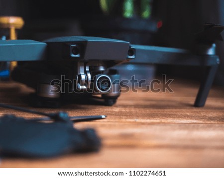 close up drone device kit on a wooden surface with dark background