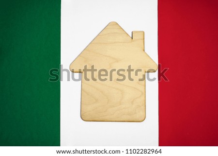 sign of wooden house with rood and pipe lie on italian flag background. 