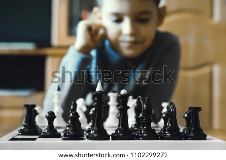 Little boy playing chess at home. Games and activities for children. Family concept.
