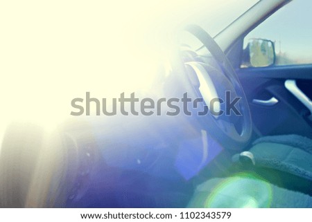 Car interior with a panel. Steering wheel and panel. Car at sunset